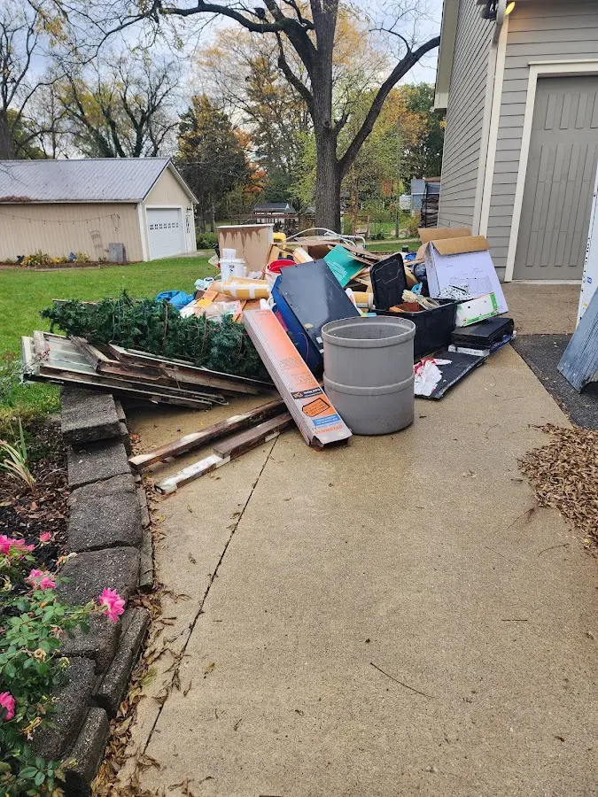 Dumpster being loaded with debris for Estate Cleanout Dumpster Rental in Rocky Hill